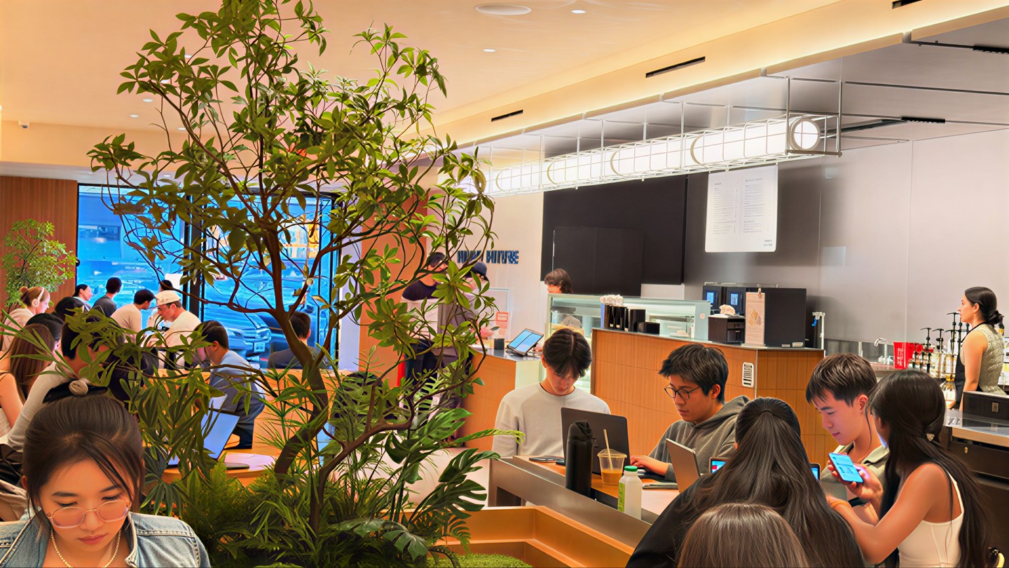 Store floor at capacity: every counter seat taken, students on laptops with drinks, staff working behind the bar